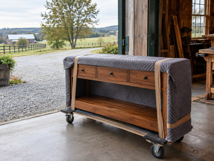 A blanket-wrapped solid wood console at a country workshop door